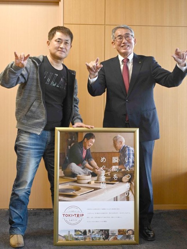 プロレスラーのモノマネでポーズをとる神奈月さんと加藤淳司市長＝土岐市役所