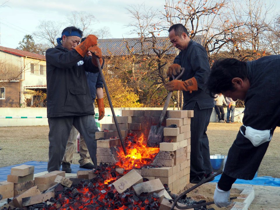 炉を壊し、鉄の塊を取り出す佐野元治さん（左）。＝関市平和通、せきてらす