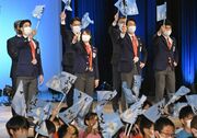祝賀報告会で小旗を振る（左から）堀島行真、村瀬心椛、永井秀昭、岩本啓吾の４選手＝２２日午後２時４８分、岐阜市橋本町、じゅうろくプラザ