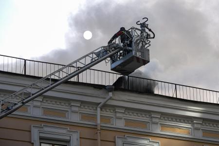 　２８日、ロシアの無人機攻撃を受けたウクライナ国立科学アカデミーの建物で、対応に当たる消防隊員ら＝キーウ（ゲッティ＝共同）