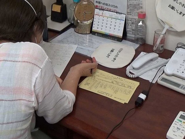 電話相談に応じる相談員