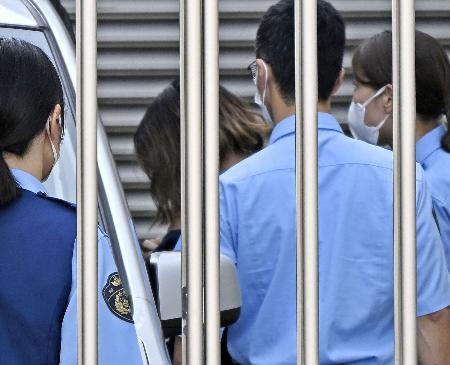 　送検のため岐阜北署を出る神原美希容疑者（奥左）＝１５日午前９時４１分