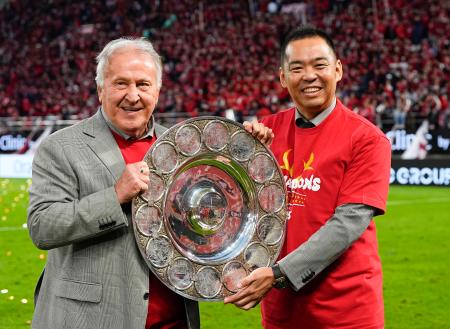 　サッカーＪ１で９季ぶりに優勝し、シャーレを手に写真に納まるジーコさんと鹿島の小泉文明社長（右）＝６日、メルカリスタジアム