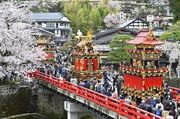 桜の咲く中橋に並んだ祭り屋台＝１５日午前９時３８分、岐阜県高山市内