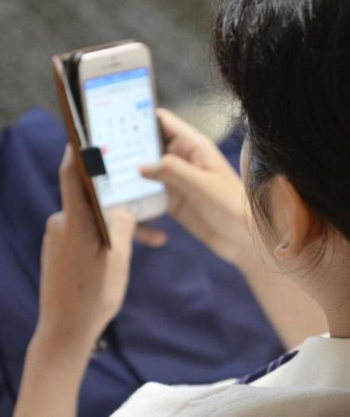 　スマートフォンを操作する人＝東京都内