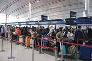 　春節に合わせた大型連休の初日、北京首都国際空港で日本便などをあつかうカウンターにならぶ人たち＝１５日（共同）