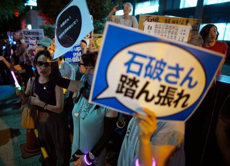 　首相官邸前で開かれた、石破首相を激励する集会に参加した人たち＝２５日夜