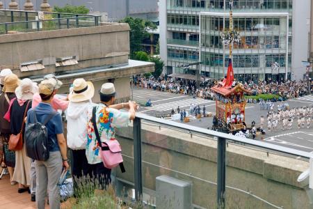 　２０２４年７月、京都市役所の屋上から祇園祭の山鉾巡行を見る参加者ら（同市提供）