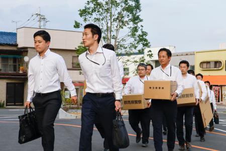 　群馬県桐生市役所へ家宅捜索に入る埼玉、群馬両県警の捜査員ら＝１９日午後６時