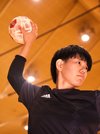 豊島梨奈主将にシュートを決める時の構えを見せてもらった。ボールをつかみ、手首をひねってゴールへと投げる＝高山市中山町、飛騨高山ビッグアリーナ