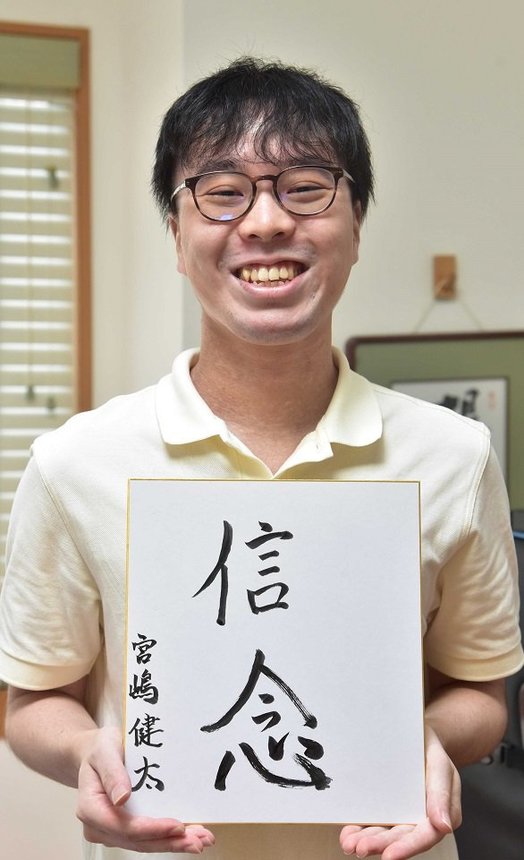 座右の銘をしたためた色紙を手にする宮嶋健太さん＝岐阜市弁天町の自宅