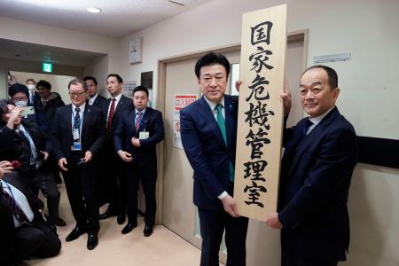 　「国家危機管理室」の看板をかける木原官房長官（右から２人目）＝２０日午前、内閣府