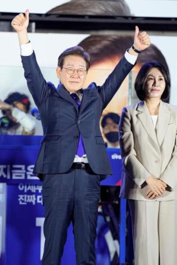 　韓国大統領選で当選を確実にし、支持者の前で両手を上げる「共に民主党」の李在明前代表＝４日未明、ソウルの国会前（共同）