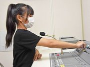 放送室でラジオに切り替える放送委員の児童