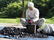 松炭をナタで切る福留房幸さん＝同市内
