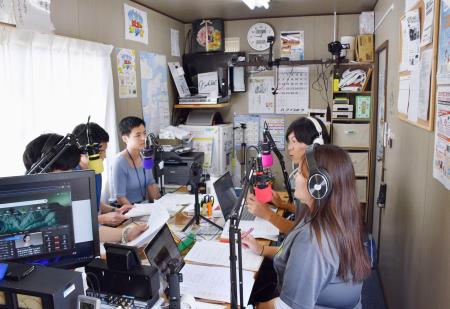 　臨時災害放送局「まちのラジオ」の生放送を行うメンバーら＝７日午後、石川県輪島市