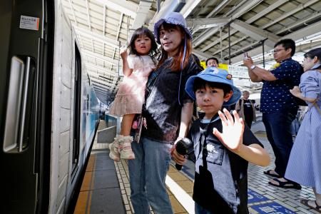 　お盆の帰省ラッシュが本格的に始まり、新幹線に乗り込む親子＝８日午前、ＪＲ東京駅