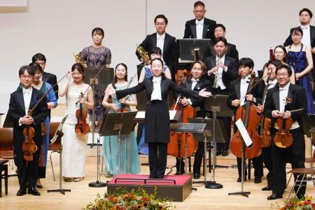 　観客の拍手に応える沖澤のどかさん（中央）＝６日午後、青森市