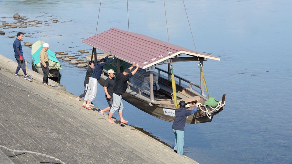クレーンで川に下ろされる観覧船＝関市小瀬、長良川左岸