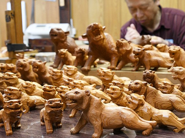 新年に向け制作がピークを迎えた一位一刀彫のトラの置物＝６日午後、高山市本町、津田彫刻