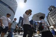 　今年初の猛暑日となった東京・銀座を歩く人たち。気象庁は東海、関東甲信が梅雨明けしたとみられると発表した＝２０日午後