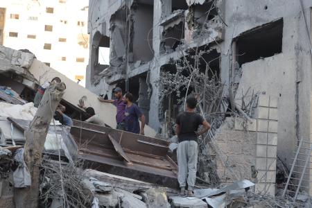 　ガザ北部ガザ市で、イスラエル軍の攻撃により破壊された住宅に集まるパレスチナ人＝２９日（ゲッティ＝共同）