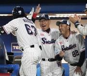 　６回、先制ソロを放った増田（左）を迎えるヤクルト・池山監督（中央）＝神宮
