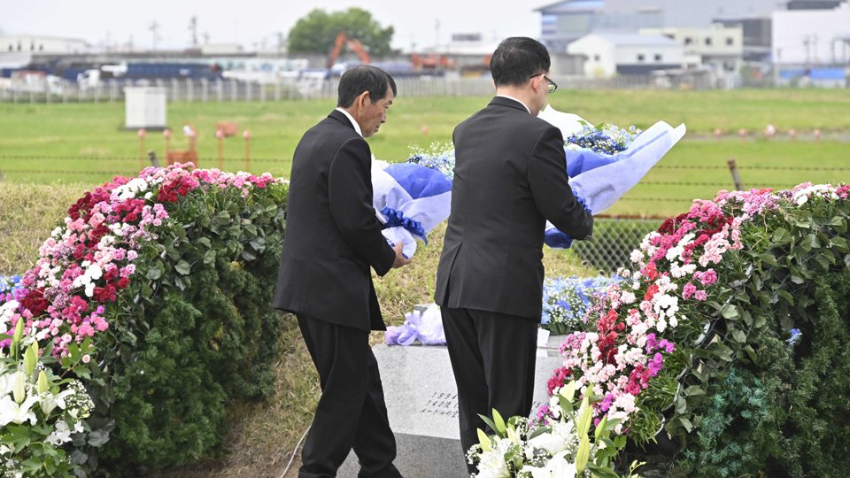 事故から３０年の慰霊式典で献花する遺族会の山本昇会長（左）２６日午後１時５分、愛知県春日井市、やすらぎの園