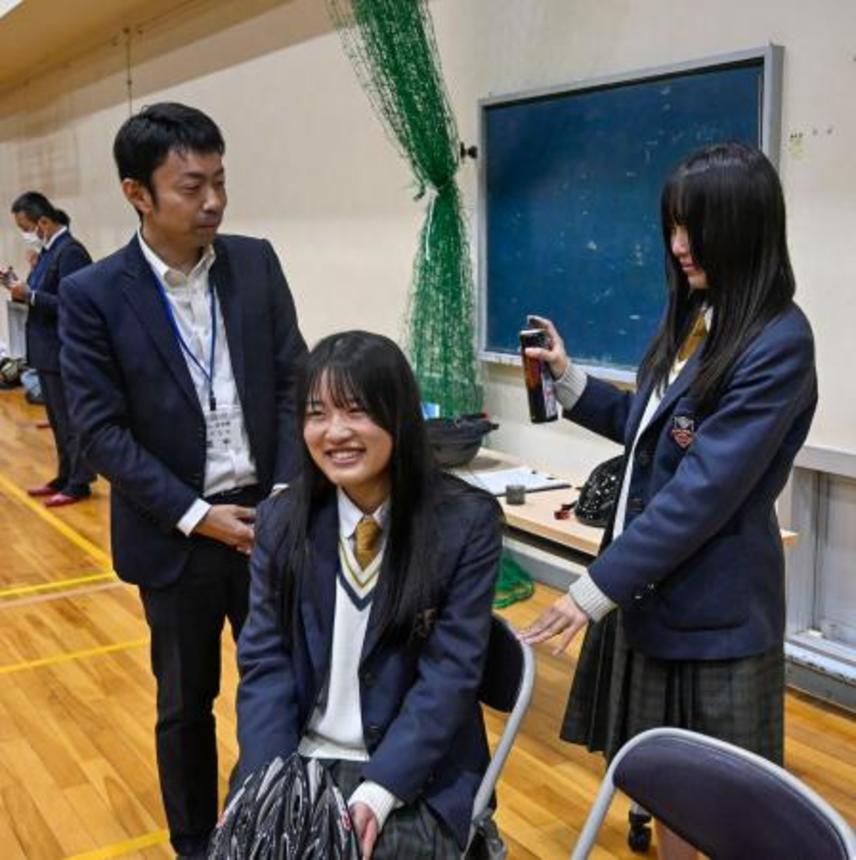 　交通安全研修会ですぐにリセットできるヘアスタイリング方法を実践する高校生ら＝１８日午後、兵庫県西脇市