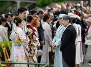 　春の園遊会で、五輪フィギュアスケート・ペアで金メダルの三浦璃来選手（左手前）、木原龍一選手（同手前から２人目）と言葉を交わされる天皇、皇后両陛下＝１７日午後、東京・元赤坂の赤坂御苑