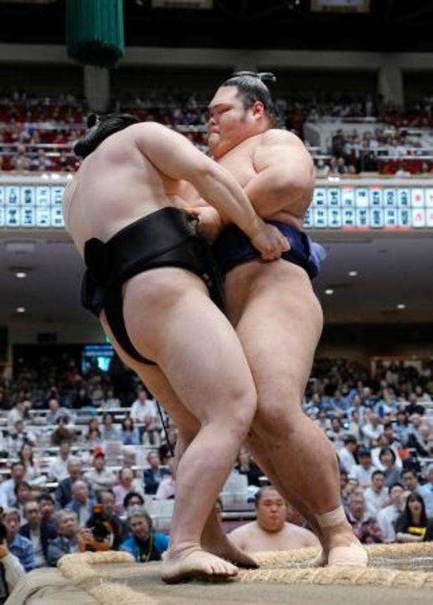 　一意（右）が寄り切りで西ノ龍を破り、十両優勝を決める＝両国国技館