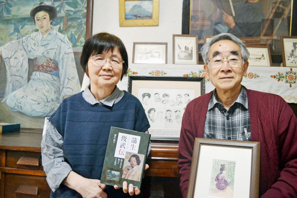 蒲生俊武について書いた著作を手にする蒲生桃子さんと夫の俊敬さん。背景にあるのは俊武の作品＝東京都杉並区の蒲生さんの自宅