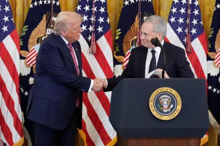 　米政権で暗号資産（仮想通貨）を担当するサックス氏（右）と握手するトランプ大統領＝１８日、ワシントン（ＡＰ＝共同）