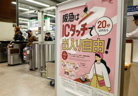 　交通系ＩＣカードを使って入場券なしで改札内に滞在できるサービスが始まったことを伝えるポスター＝１９日、阪急大阪梅田駅