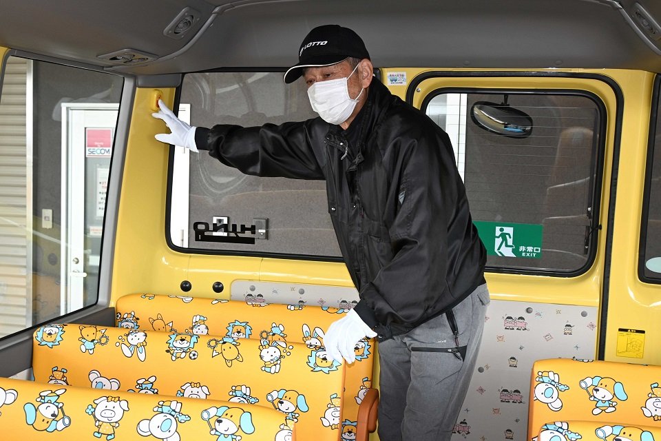安全装置のスイッチを押す運転手＝３０日午前９時２０分、本巣市下真桑、真桑幼児園