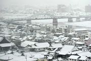 雪化粧した岐阜市内。奥は忠節橋＝１７日午前８時４４分、岐阜市役所展望スペースから望む