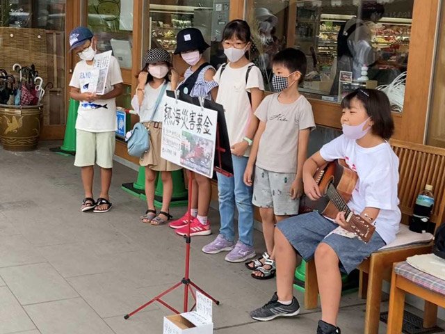 ギターを弾きながら歌う森安ひばりさん（右端）＝高山市相生町