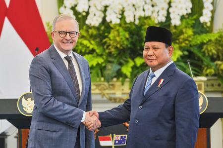 　合同記者会見後に握手するオーストラリアのアルバニージー首相（左）とインドネシアのプラボウォ大統領＝１５日、ジャカルタ（ＡＰ＝共同）