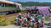 HC８５系（特急ひだ１号）を出迎える子どもたち＝１日午前、高山市一之宮町