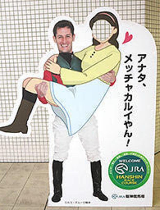 今年絶好調のミルコ・デムーロ騎手。阪神競馬場のフォトスポットのパネルでは「アナタ、メッチャカルイやん！」のポーズ