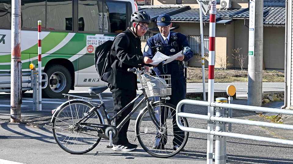 青切符制度についての説明を聞く高校生（左）＝飛騨市古川町上気多
