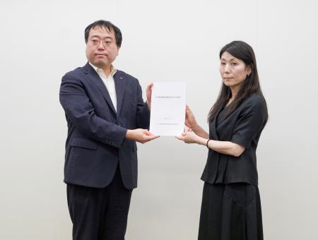 　厚労省の担当者（右）に要望書を手渡す長崎県の新田惇一福祉保健部長＝１５日午後、厚労省