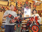車いすを手にする「はな工房」代表の阿蘇講平さん（左）ら＝揖斐郡池田町上田、はな工房