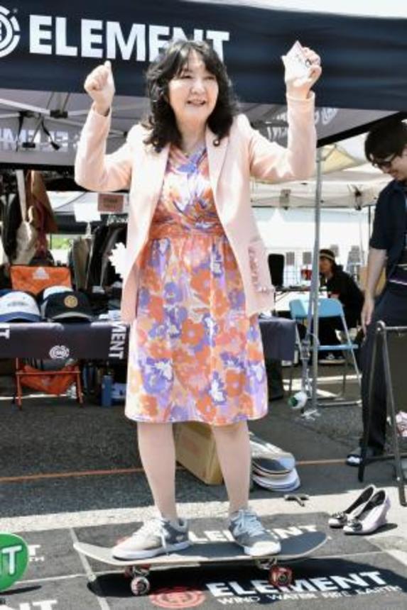 　東京・お台場のイベントで、スケートボードに乗る片山財務相＝１６日午前