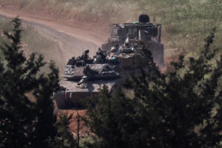 　２５日、国境のレバノン側へ入るイスラエル軍の戦車（ロイター＝共同）