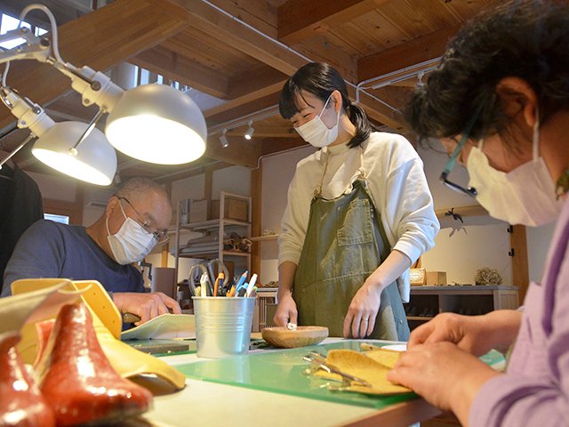 受講者と談笑しながら、靴作りを教える望月茜さん（中央）＝美濃市常盤町、ジョウノ靴工房